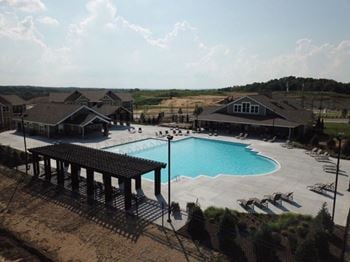 A large swimming pool in front of a house